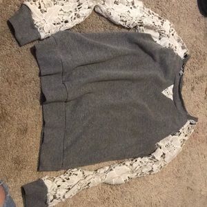 A grey long sleeve shirt with white lacing